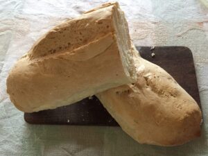 Two pieces of sliced bread on the wooden plate