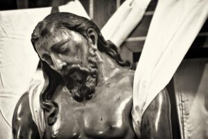 Closeup shot of the crucifix with blood dripping on the body