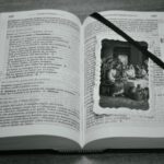 An open bible with jesus family photo under the bookmark