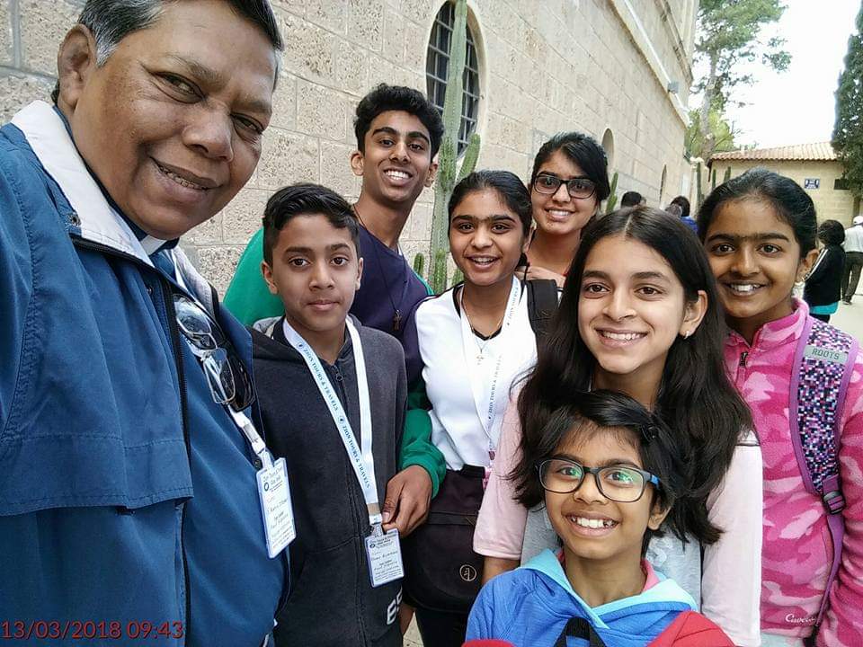 A man clicking a selfie with the students