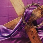 Wooden lent cross with purple cloth on it