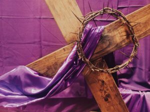 Wooden lent cross with purple cloth on it