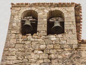 The stones of the temple with rocks and two bells