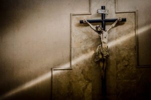 Statue of Jesus Christ crucifix on the cream wall