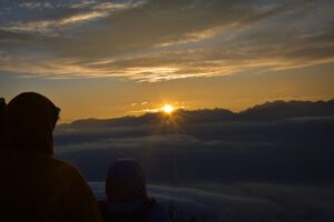 People viewing the sunset from the snow