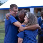 Paul Verderber, president of Gratia Vobis Ministries, his wife Mary Ann, and Fr. Maurice Emelu embrace in a joyful hug during the Jubilee of Hope event on July 10, 2025