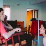 Caregiver speaking to elderly resident in nursing home