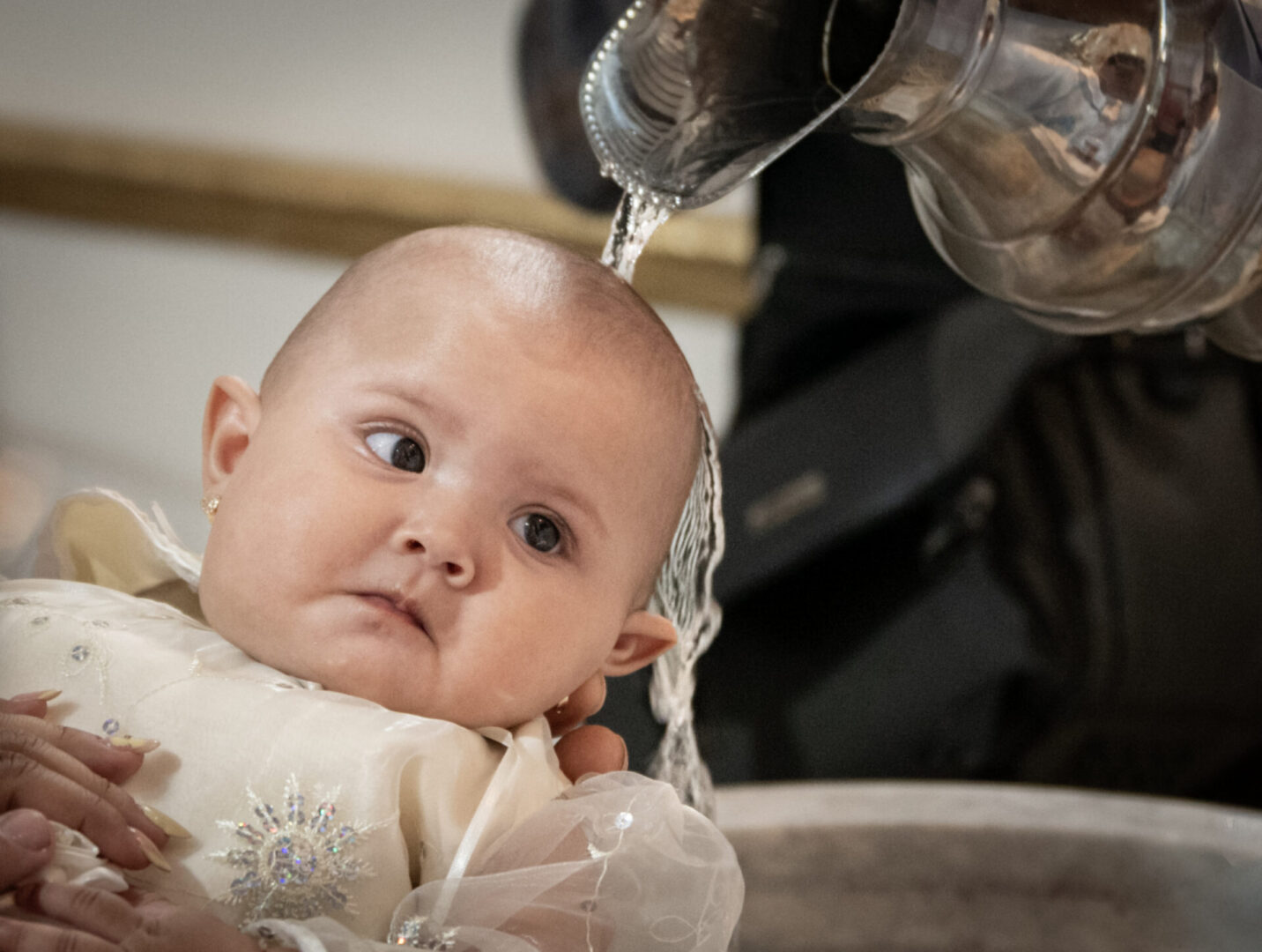 Baby in a Baptism font by Carolina BR courtesy of Cathopic
